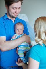 Happy Young Attractive Family parents with Newborn Baby