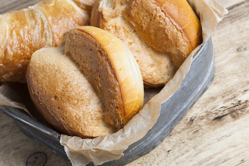french breakfast buns bread roll and croissant on vintage tray and wood