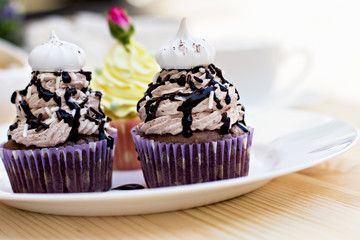 Chocolate Cupcake with chocolate frosting on the table