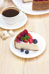 Cheesecake with fresh berries o the table