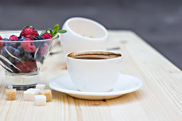 Summer berries (strawberries, raspberries, blueberries, blackberries) and a cup of coffee "espresso". A healthy breakfast, snack.