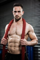 Obraz premium Shirtless man with battle rope around neck