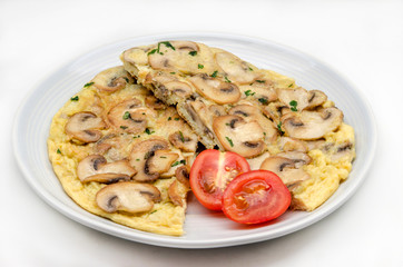 Delicious omelet with mushrooms and tomatoes