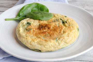 Omelet with spinach on plate
