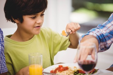 Boy having a meal at dining table