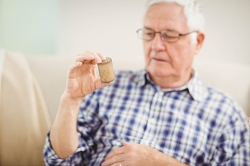Senior man holding a pill bottle