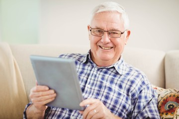 Senior man using digital tablet