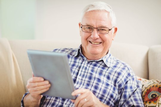 Senior man using digital tablet