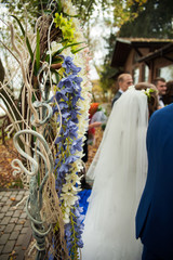 stylish decorated arch  with flowers and ribbons at the receptio