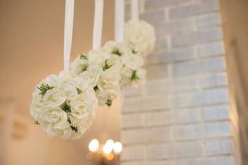 stylish decorated interior in a restaurant with white roses roun