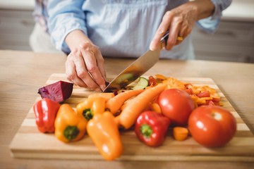 Senior woman chopping vegetables