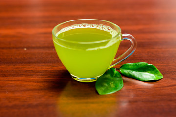 cups of green tea on wooden table