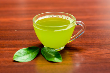 cups of green tea on wooden table