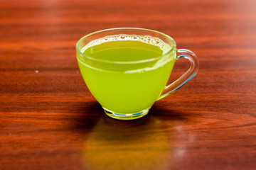 cups of green tea on wooden table