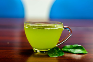 cups of green tea on wooden table