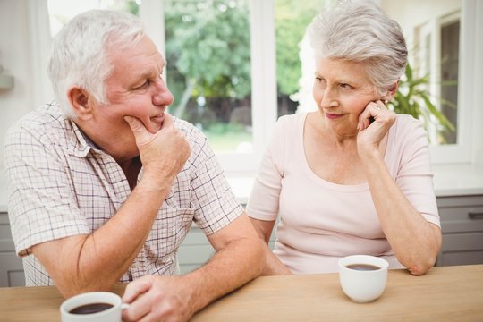 Senior Couple Talking To Each Other While Having Coffee