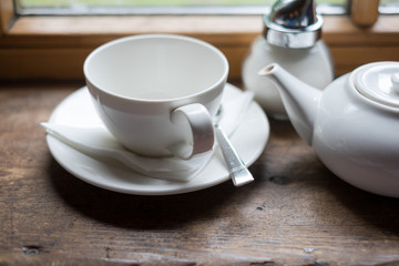 Fototapeta na wymiar Tea cup pot and sugar on wood table
