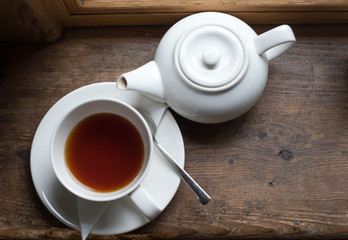 Tea cup pot and sugar on wood table