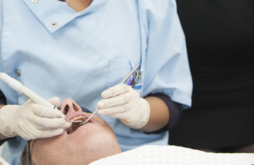 Visiting the dentist having a checkup, clean and work done. Close up images of the dentist working on and in a mouth