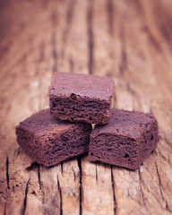 Chocolate brownie mini bites on a  vintage  wooden surface