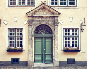 Vintage door on  a medieval building facade in old Riga city, La