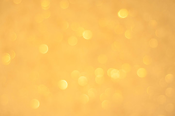 Gold glittering christmas lights. Blurred abstract background