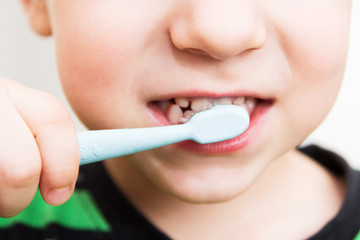 child's teeth with a toothbrush
