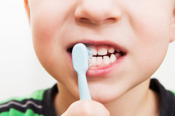 child's teeth with a toothbrush
