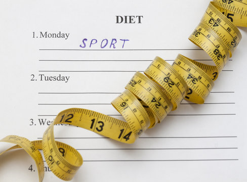 paper with blank diet plan and yellow measure tape