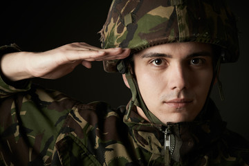 Portrait Of Soldier In Uniform Saluting