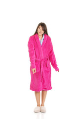 Woman in pink bathrobe pointing down.