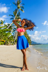 Beautiful teenage black girl in blue skirt and pink bra on the b