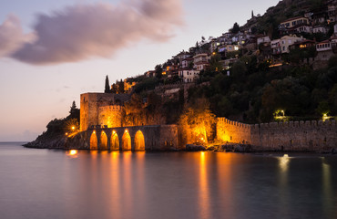 Evening view of harbour, fortress and ancient shipyard in Alanya, Turkey.
