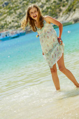 Fototapeta premium Summer vacation, portrait of beautiful, happy, young girl on the beach