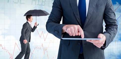 Composite image of businessman sheltering under black umbrella