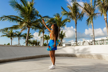 Beautiful teenage black girl in blue skirt take selfie with her