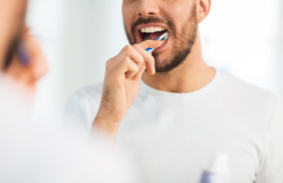 Close Up Of Man With Toothbrush Cleaning Teeth