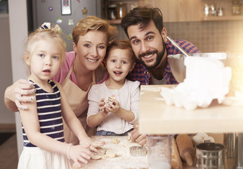 Portrait of four people family in the kitchen