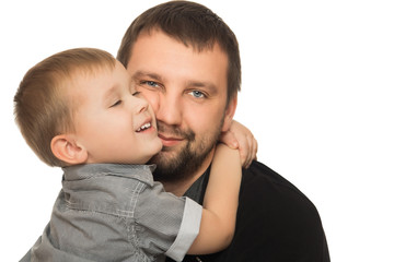 Happy little blond boy tenderly hugging arms of his beloved dad - Isolated on white background