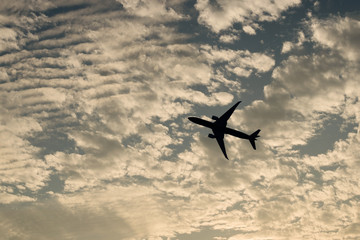 airplane against sunset sky background