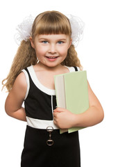 Adorable little girl schoolgirl presses a hand to his chest a thick book . Closeup - Isolated on white background