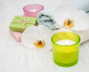 Fototapeta na wymiar Orchids, candle, towel and handmade soap