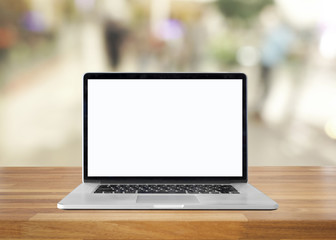 Laptop with blank screen on table. interior background, blurred