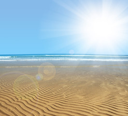 Fototapeta na wymiar Wavy sandy beach at low tide in sunny day.