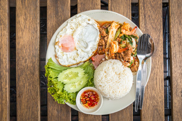 Rice topped with stir-fried combination of pork, chicken, squid,