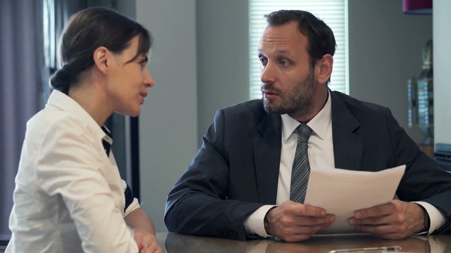 Businesswoman talking with businessman during job interview
