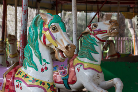 color children's carousel horse in a city park