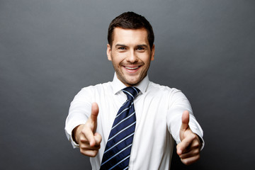 Handsome stylish businessman on grey background