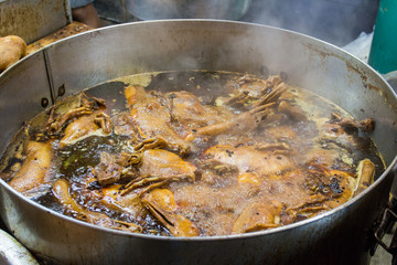 Duck stewed with gravy in big stainless pot