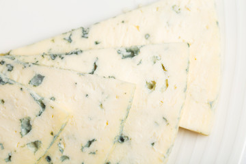 Closeup of delicious sliced roquefort cheese.
